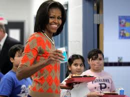 Michelle still doesn't "get it." Here she is with a carton of milk as she role models "healthy" eating in our schools.