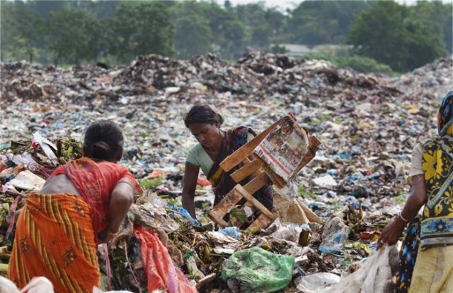 Women search for recyclable items among heaps of rubbish at a municipal waste dumping site on World Environment Day in Dimapur, Nagaland. 